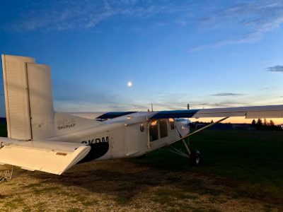 Petit avion sur une piste au coucher du soleil avec la lune
