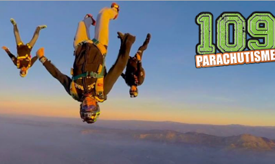 Trois parachutistes en chute libre faisant des acrobaties.