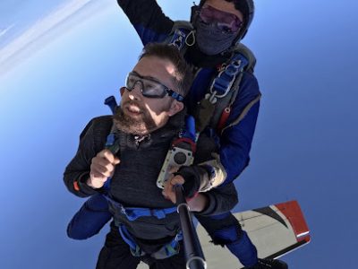 Deux personnes en parachutisme avec la Terre à l'arrière-plan